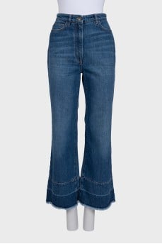 Blue flared jeans with fringe