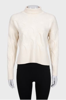 White turtleneck sweater with a textured pattern