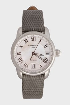 Silver watch with a green leather strap