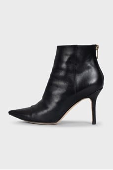 Black leather ankle boots with a gold zipper
