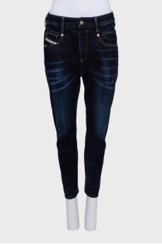 Dark blue tapered fit jeans with a distressed effect