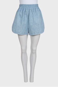 Light blue shorts with elastic waistband and pockets