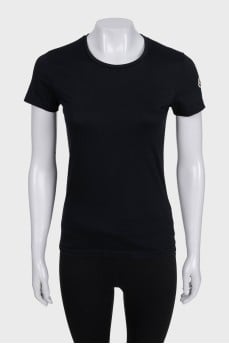 Black T-shirt with a patch on the sleeve
