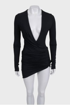 A fitted dress with sleeves decorated with draping