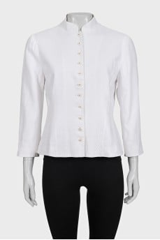 The white jacket is decorated with embroidery