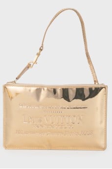 Golden clutch from a brand's logo