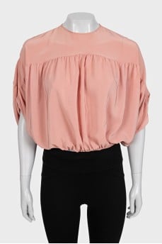 Cropped silk blouse with a button