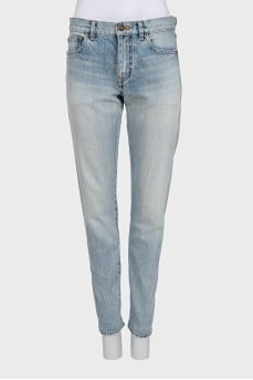 Light blue straight leg jeans with a ripped effect at the bottom