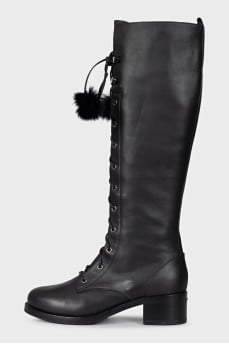 Black leather boots decorated with pom-poms