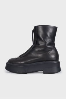 Black leather boots with a zipper