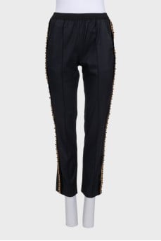 Black tapered trousers with decorated stripes