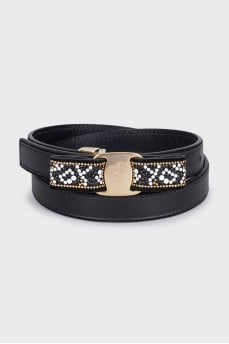 Black leather belt with a decorated buckle
