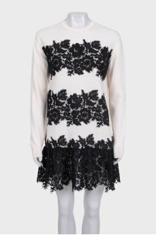 White dress with long sleeves decorated with lace