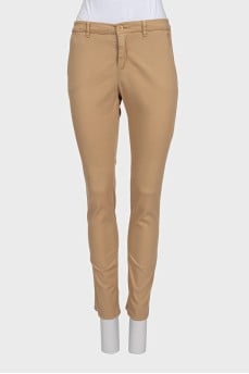 Beige tapered trousers with a mid-rise