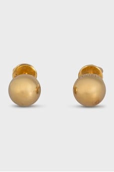 Gold earrings in the shape of spheres