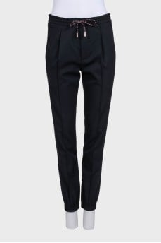 Men's black tapered trousers with zippers at the bottom