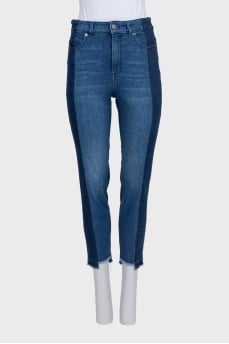 Blue jeans with contrast seams and raw hem