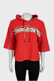 Cropped orange hoodie decorated with sequins