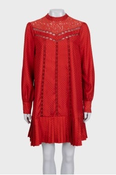 Red dress with long sleeves decorated with perforations