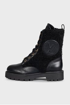 Black leather boots with a gold logo