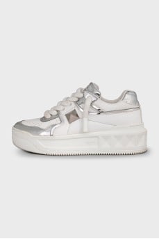 White leather sneakers with silver accents