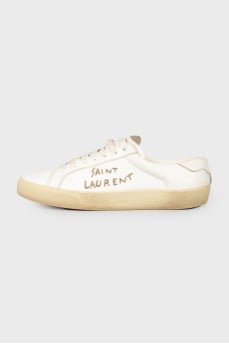 Leather sneakers with an embroidered brand's logo on the sides