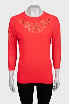 Pink jumper decorated with perforations