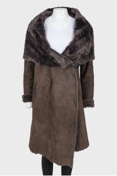 Sheepskin coat on fur with a wide collar