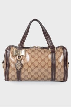 Leather bag with a golden log of brand