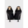 Patent leather black shoes with gold trim