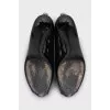 Patent leather black shoes with gold trim