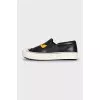 Black leather slip-ons with print