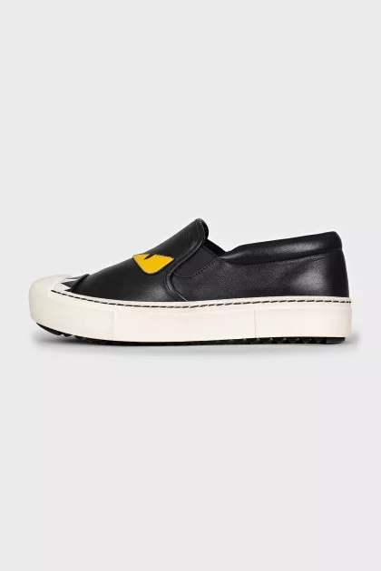 Black leather slip-ons with print