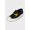 Black leather slip-ons with print