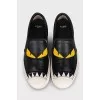 Black leather slip-ons with print