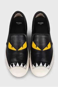 Black leather slip-ons with print