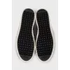 Black leather slip-ons with print