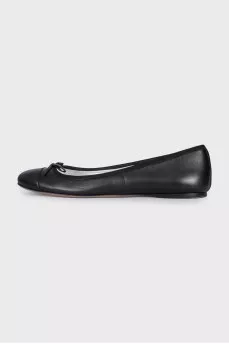 Black leather ballet flats with a bow