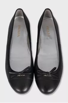 Black leather ballet flats with a bow