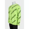 Green oversized jumper with a signature monogram