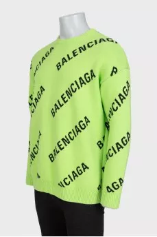 Green oversized jumper with a signature monogram