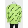 Green oversized jumper with a signature monogram