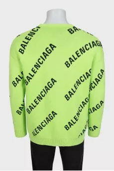 Green oversized jumper with a signature monogram