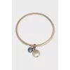 Gold bracelet with asymmetrical pendants
