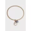 Gold bracelet with asymmetrical pendants