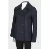 A shortened coat on a double -breasted fastener, with a tag