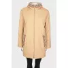 Reversible coat with knitted hood and tag