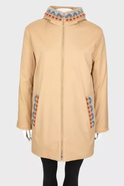 Reversible coat with knitted hood and tag