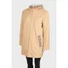 Reversible coat with knitted hood and tag