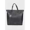 Leather bag with branded accessory